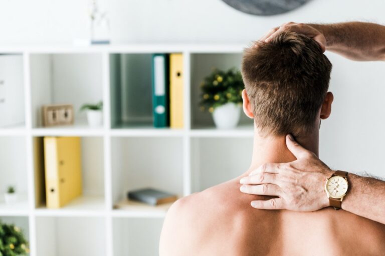 Edmonton physiotherapist assessing a patient's neck for whiplash after a motor vehicle accident