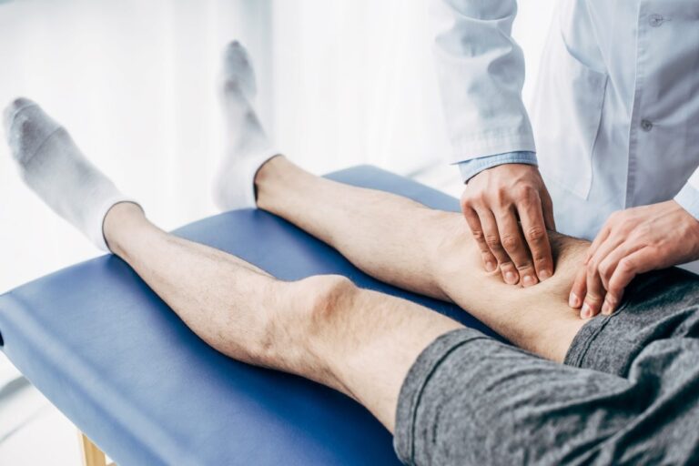 Physiotherapist delivering shockwave therapy to a patient's leg at Beverly Physiotherapy Edmonton