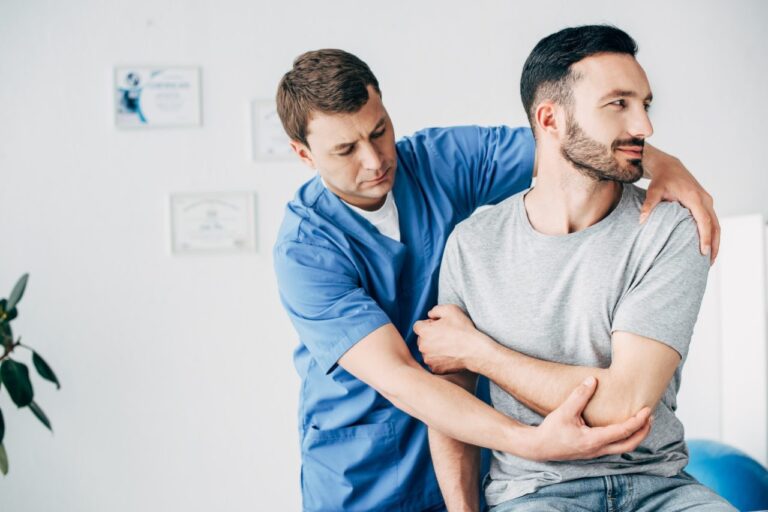Registered massage therapist treating a patient's arm at Beverly Physiotherapy Edmonton